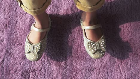 Top-view-of-child-feet-wearing-sandal-at-early-morning