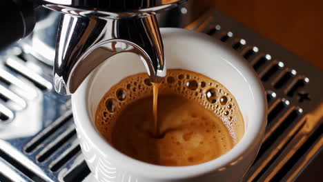 fresh espresso being poured from a coffee machine