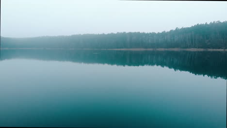 walking along the bridge towards the lake from the point of view of the observer