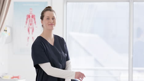 Portrait-of-happy-caucasian-female-doctor-in-hospital-with-copy-space,-slow-motion