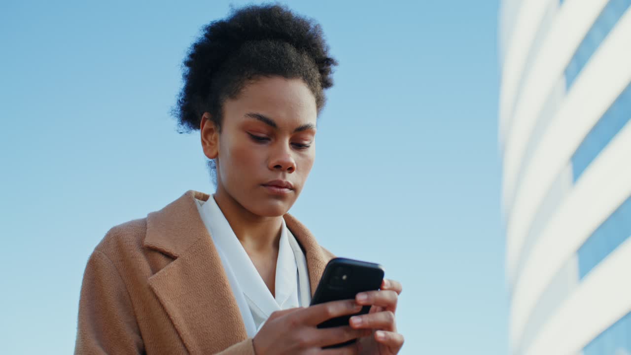 Woman using phone in city