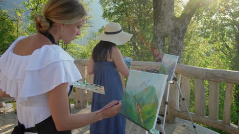 women painting outdoors in nature