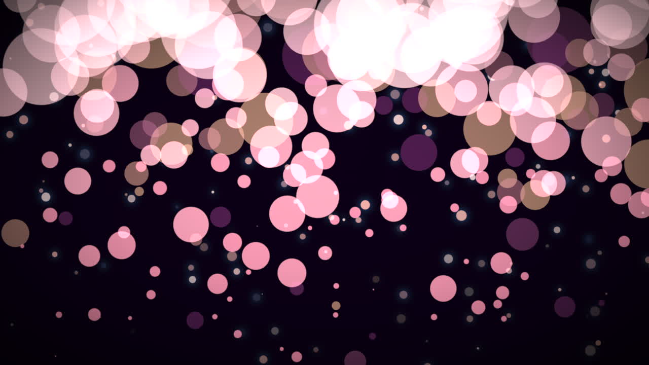 모션 및 플라이 핑크 입자 및 어두운 배경의 둥근 보케