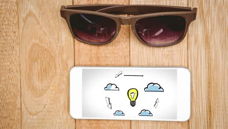 Animation-Eines-Smartphones-Mit-Symbolen-Auf-Dem-Bildschirm-Und-Sonnenbrille-Auf-Holzhintergrund