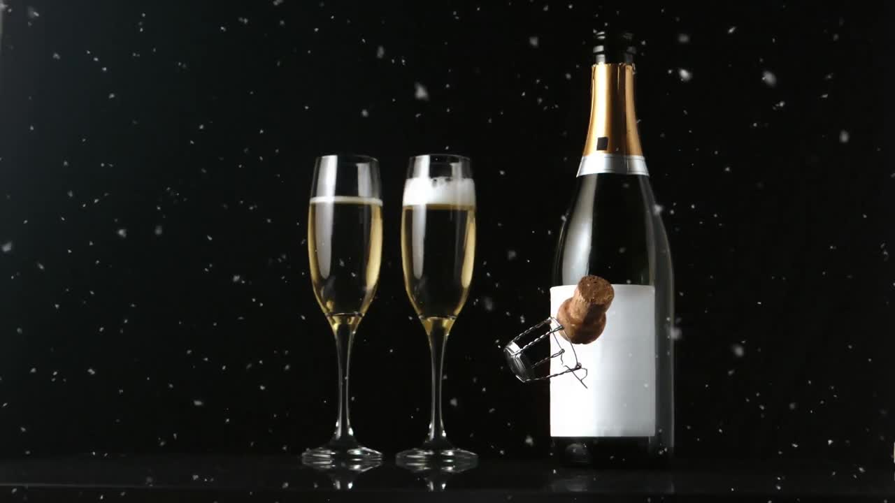 Animation af champagneflaske, to champagneglas og korkprop, der falder