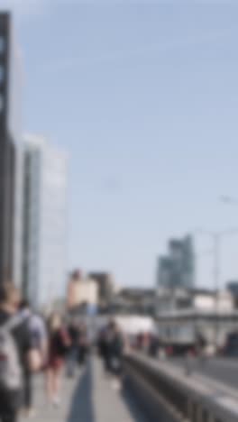 Defocused-Vertical-Video-Pedestrians-Cyclists-Commuting-London-Bridge-Office-Buildings