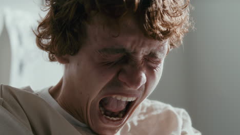 frustrated patient in straitjacket screaming during emotional breakdown