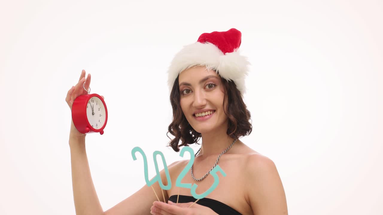Woman in Santa Hat with Alarm Clock and "2023" Numbers for New Year Celebration