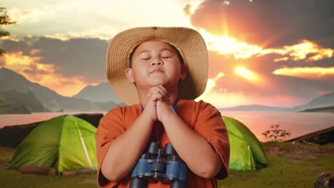 child praying outdoors at sunrise/sunset