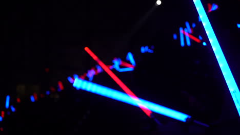 blue-and-red-light-sabers-in-a-crowd