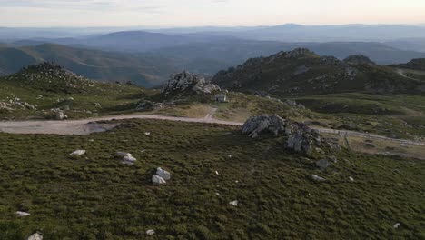 Aerial-dolly-above-dirt-road-with-mountain-hut-in-Sierra-de-san-mamede-Ourense-Spain