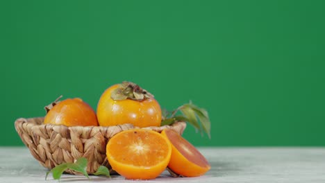 fresh persimmon in the basket slowly rotates.