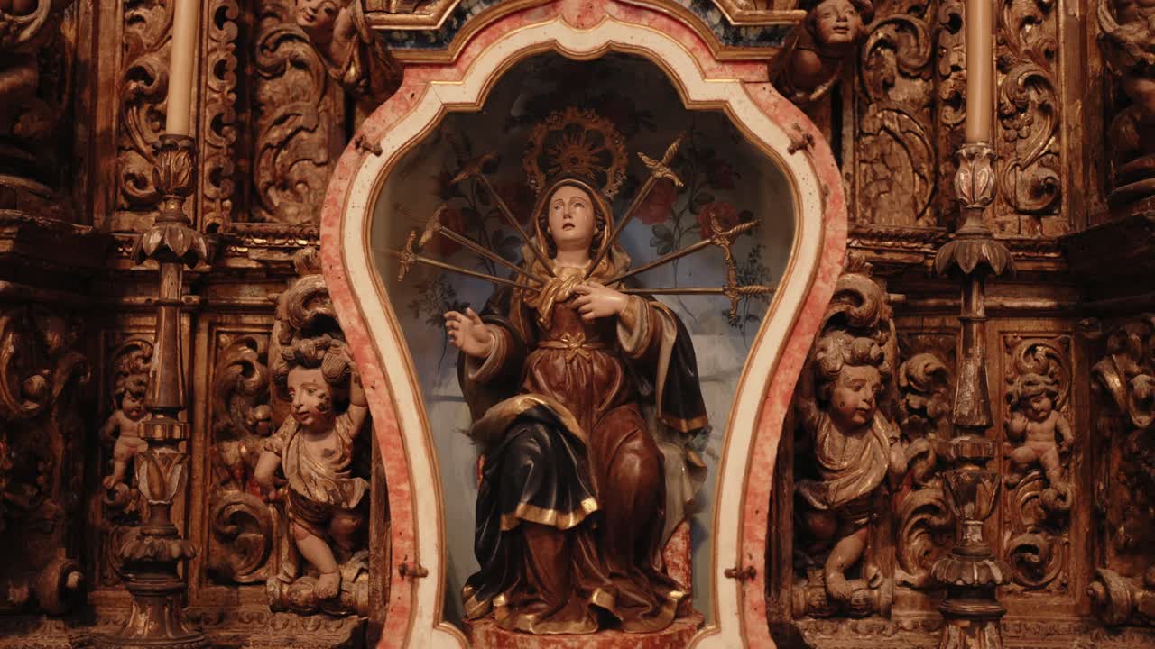Ornate wooden altarpiece with statue of Our Lady pierced by seven swords