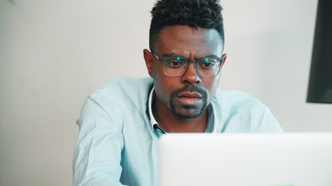 Man Concentrating on Laptop