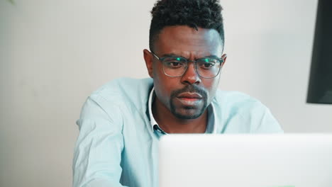 man concentrating on laptop
