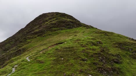 drone footage of a misty ascent of fleetwith pike's craggy ridge in the lake district national park