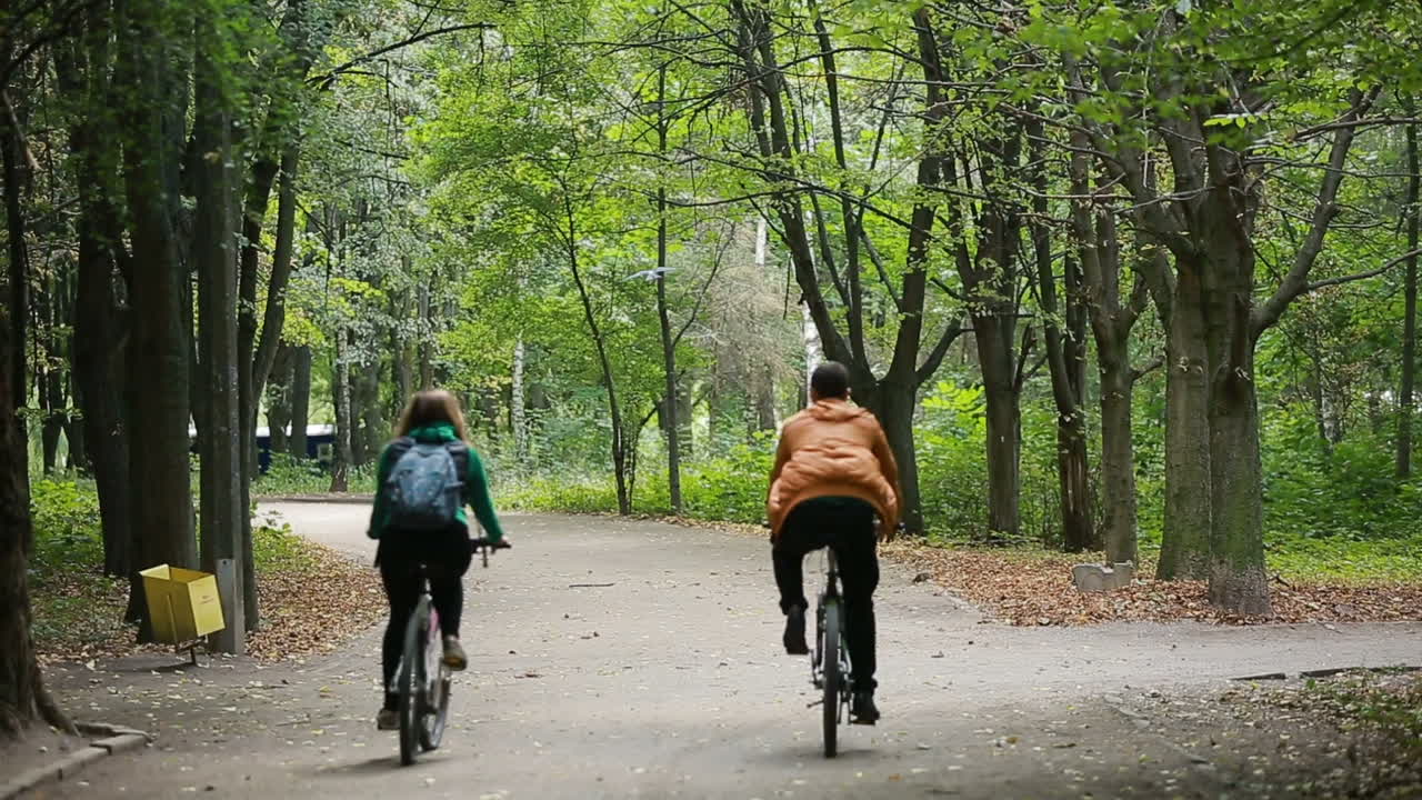 Couple Riding On Bicycles. Happy couple riding bicycle outdoors together