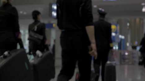 airplane crew and passengers in the airport terminal