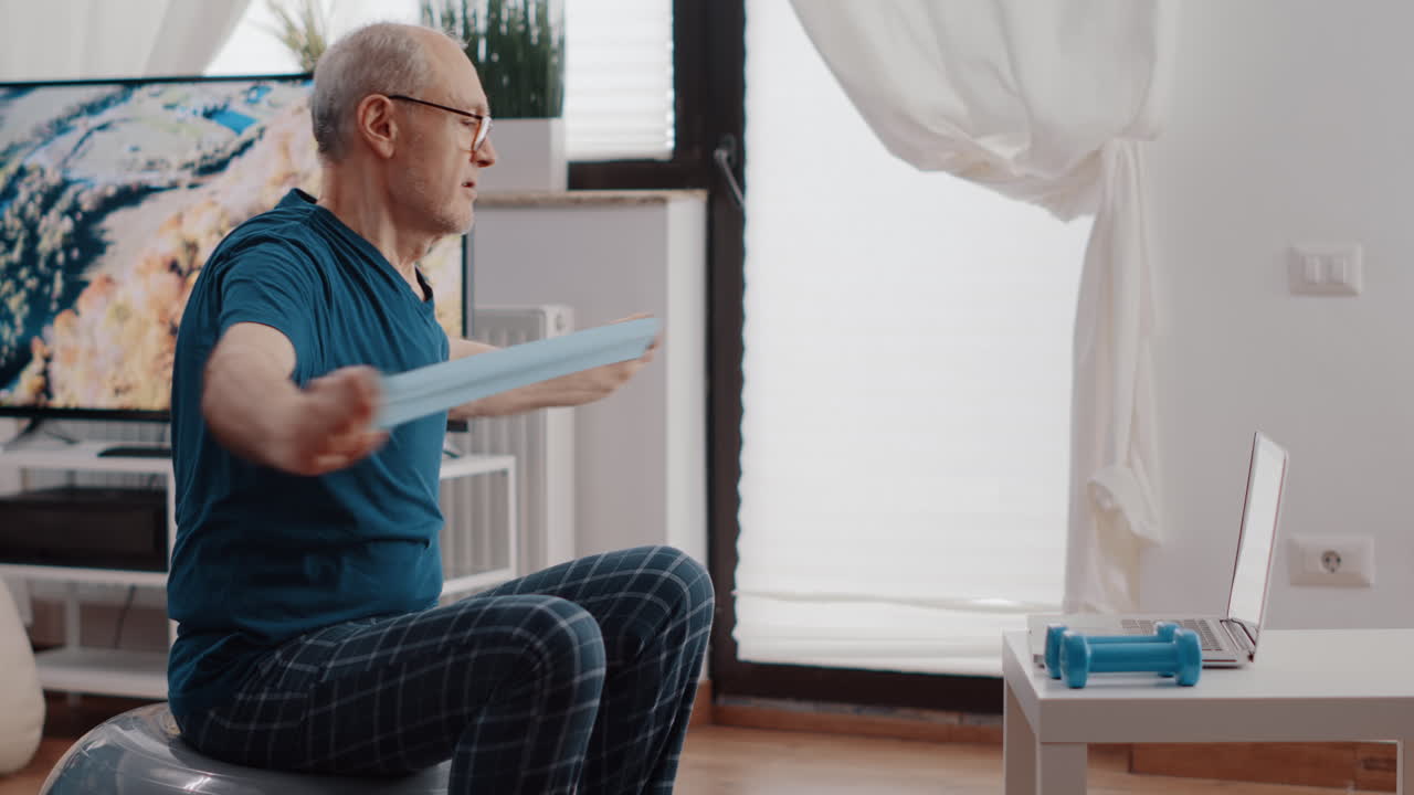 Elder man doing stretching exercise with resistance band