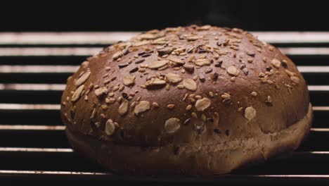 cooking a homemade burger bun on a grill