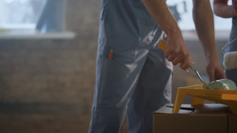 Unknown-woman-and-man-doing-home-repair-indoors.-Couple-preparing-color-inside.