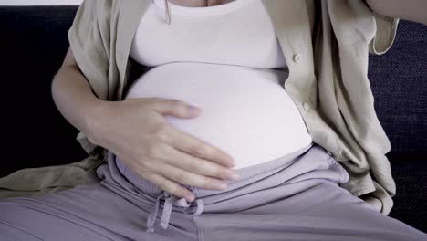 smiling pregnant woman recording video message