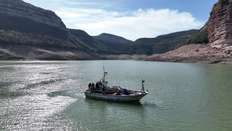 local spanish fisherman boat on drying lake in catalonia, aerial drone view