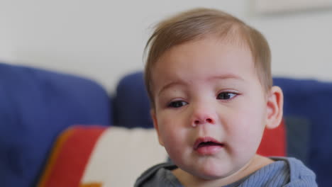 baby playing with rainbow silk ribbons in slow motion