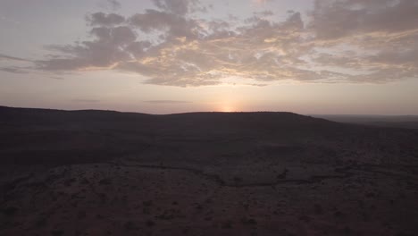 aerial drone shot of loisaba conservancy's vast landscapes, showcasing wildlife, rivers, and rolling savannahs under golden sunlight