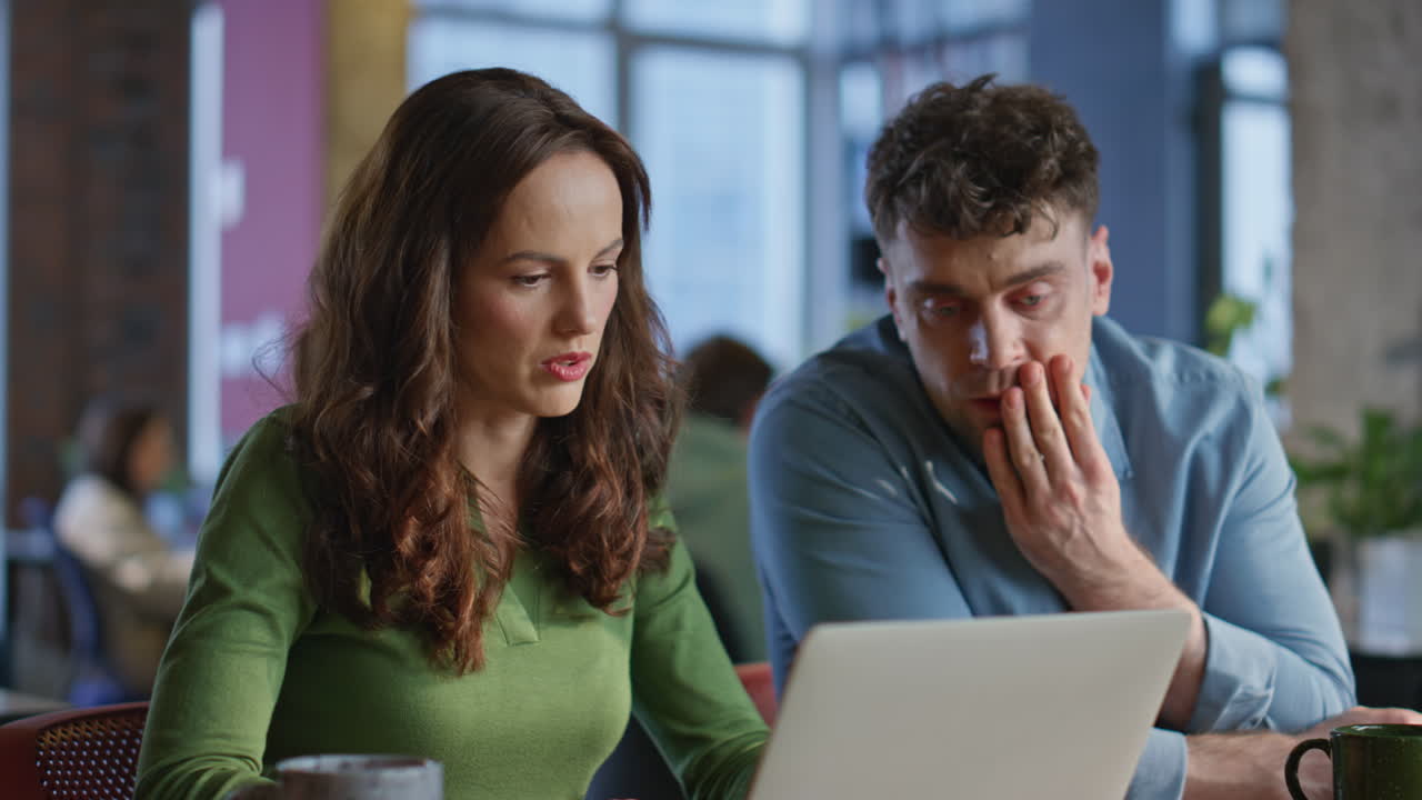 Office manager helping colleague doing work task together at workspace closeup
