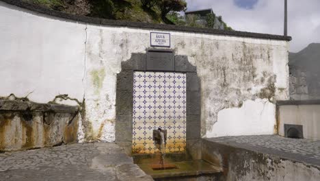 slow-moving handheld shot of a water fountain in the azores