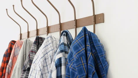 Close-up-of-various-shirts-hanging-on-hook-4k