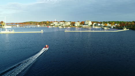 jetski ride aerial man speeding on jet-ski on tropical ocean island