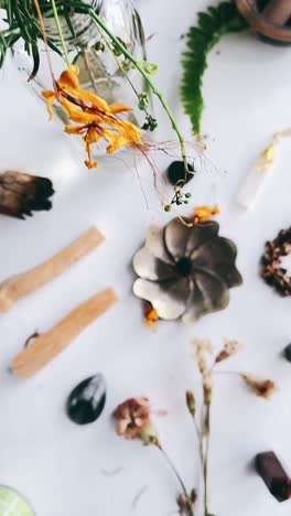 beautiful still life with flowers, crystals, and incense