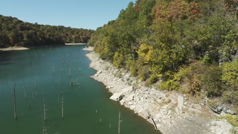 eagle hollow cave pristine lake with wooden pilings in arkansas, usa