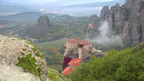 fog rises in the morning around the beautiful monasteries of meteora greece 1