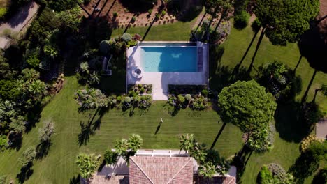 drone landing top down shot tropical villa with private swimming pool in garden