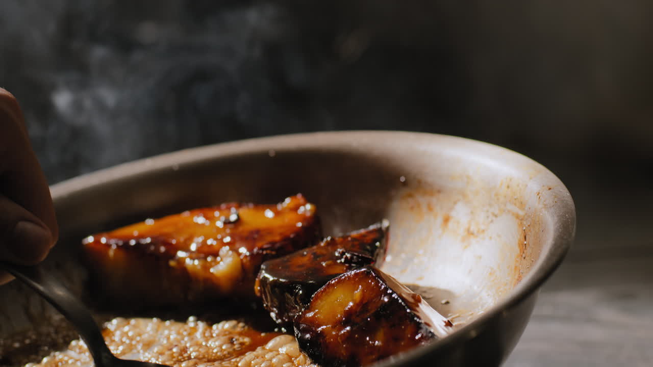 Saut&eacute;ing sweet potatoes in a sweet brown sauce in slow motion