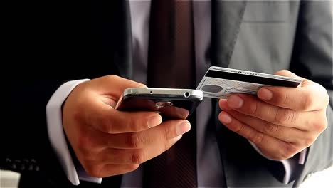 businessman making online payment with credit card and smartphone