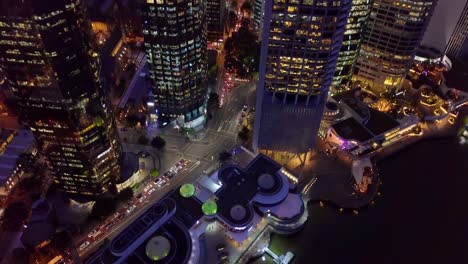 aerial tilting down view of city street intersection at night