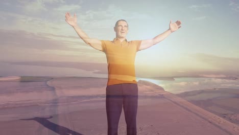 animation of sea over caucasian man with arms outstretched