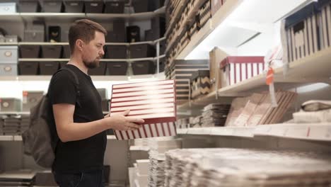 man shopping for boxes in a home goods store