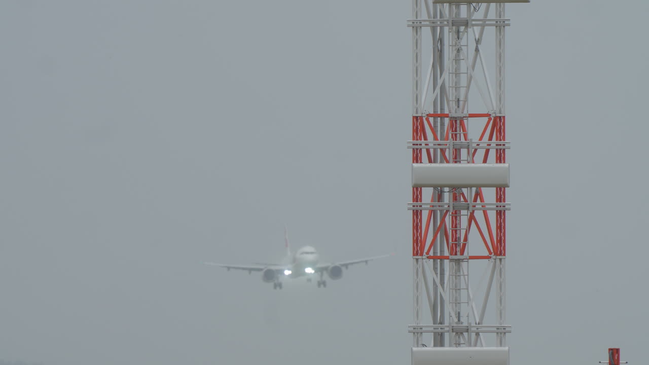 Passenger airplane landing in the airport during a cloudy day