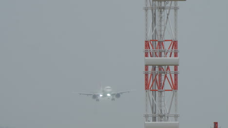 passenger airplane landing in the airport during a cloudy day