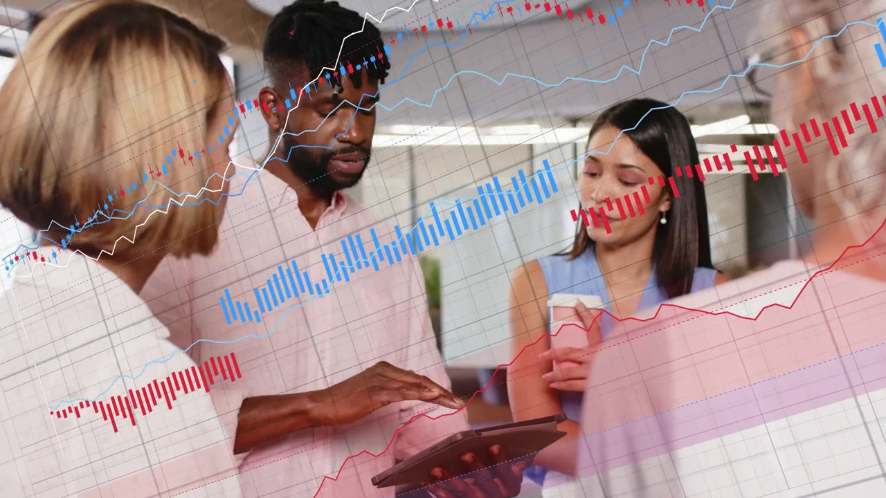 Mid adult man holding tablet tapping screen, starting red blue charts over team for business review