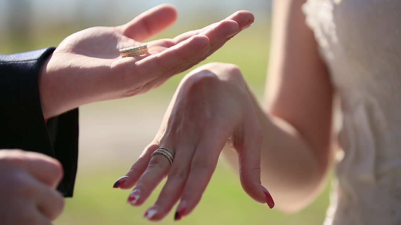 The groom puts the wedding ring on finger of the bride. Just married. The bride and groom exchange wedding rings.