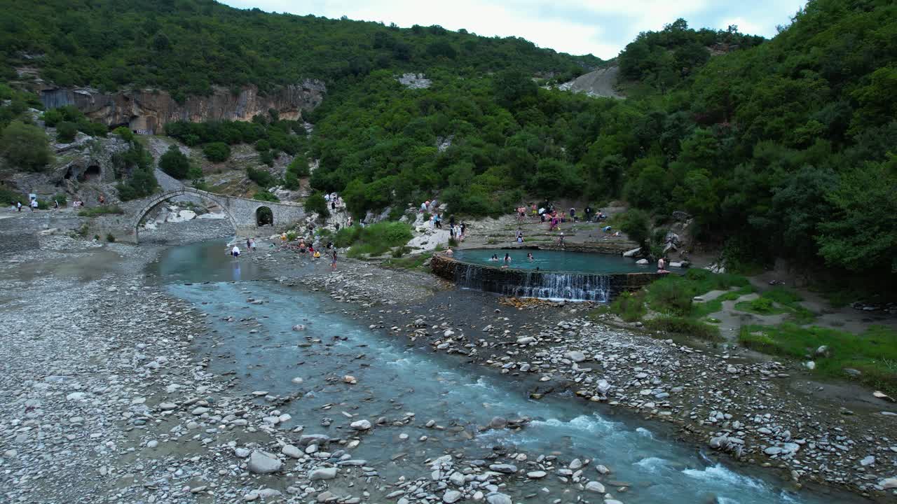 Tourists vacation nature emerald water Benje thermal springs bathing in warm natural pool Albania