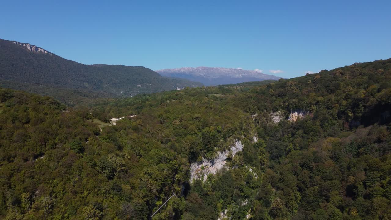 Distant drone fly at Okatse Canyon vast mountain landscape with dense forest, Mtskheta-Mtianeti, Georgia