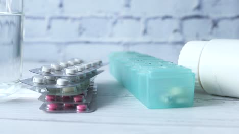 medicine and pill organizer on a wooden table