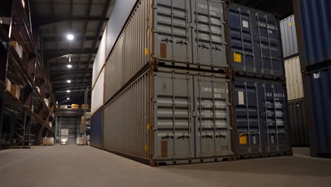 stacks of shipping containers in a large warehouse